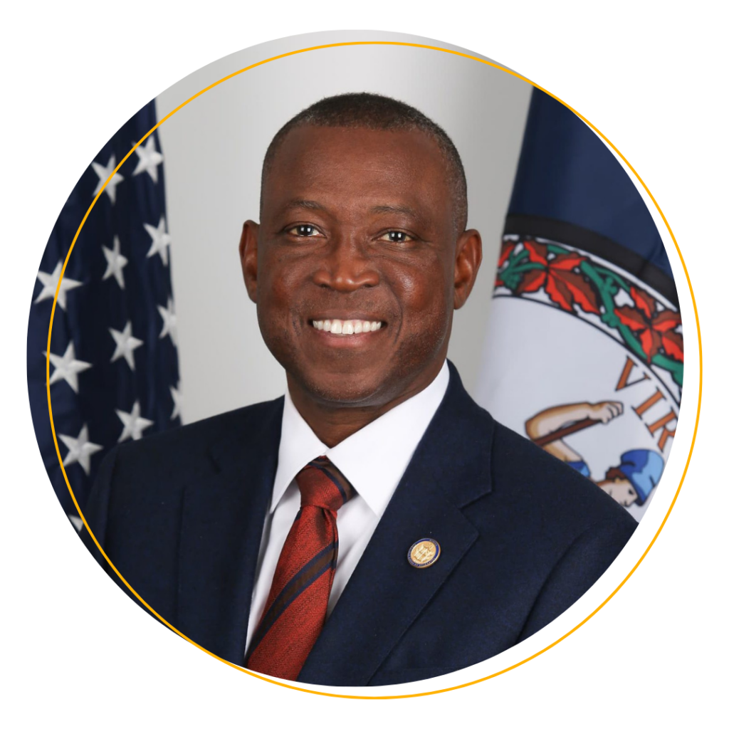 Virginia House Speaker Don Scott wearing a blue suite and red tie smiles at the camera